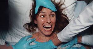 Woman in hospital bed screaming