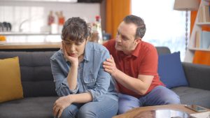 Man consoling woman